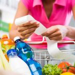Person examining a receipt while shopping for groceries