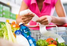 Person examining a receipt while shopping for groceries