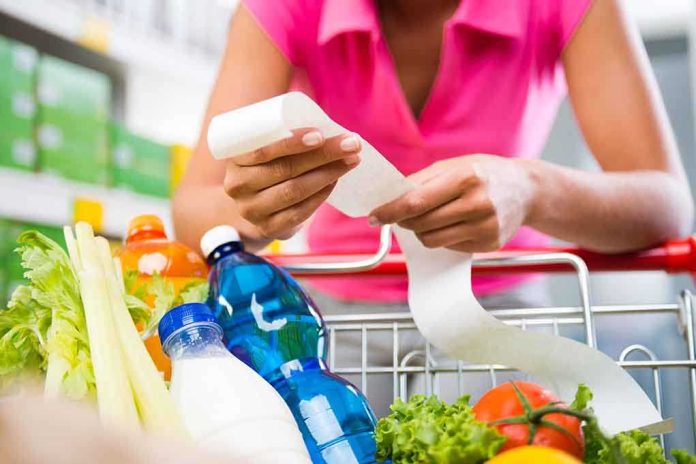 shutterstock_225994960.jpg Person examining a receipt while shopping for groceries