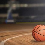 A basketball on a wooden court