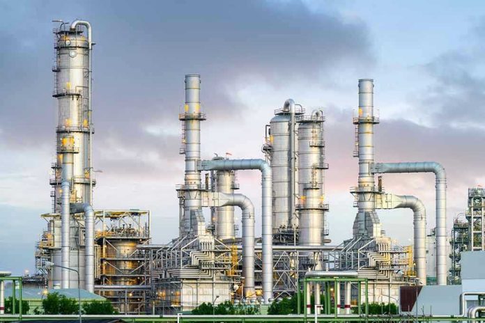 1892669737 Industrial plant with metal towers and pipes.