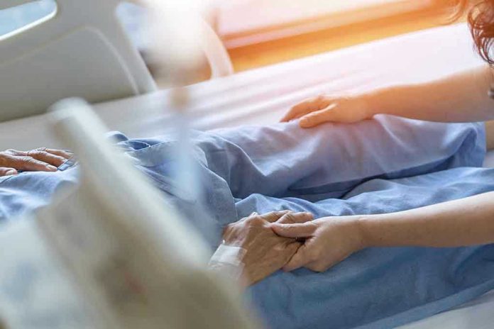 Hospital patient holding visitor's hand reassuringly.