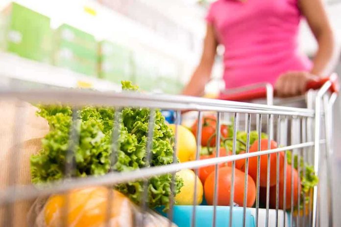 shutterstock_221704471.jpg A shopping cart filled with fresh vegetables and fruits in a supermarket