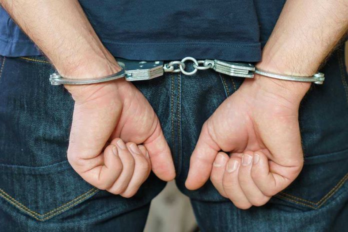 1916737259 Person in handcuffs behind their back.