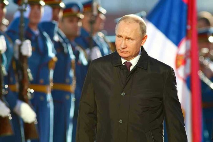 83211922 A man in dark coat at a military event.