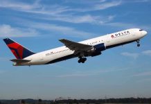 Delta airplane taking off from runway.