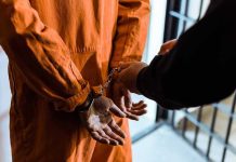Dangerous Offender FREED—Shocking Prison BLUNDER! Handcuffed person in orange jumpsuit being escorted.