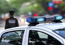 Police Officer CHARGED – Disgraceful Ignorance! Police car and officer on a city street.