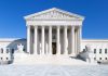 BOMBSHELL SCOTUS Ruling – Defamation Suit Stands! The Supreme Court building featuring marble columns and a clear blue sky