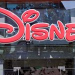 Disney Tragedy STUNS Guests — Heartbreaking! Bright red Disney logo displayed on a storefront window