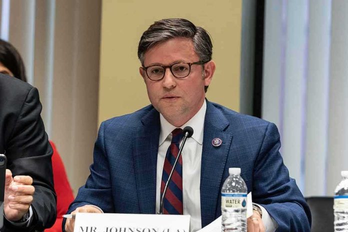 shutterstock_2290525913.jpg A public official speaking at a meeting with a nameplate in front of him