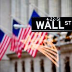 America Is BOOMING – Record Numbers Announced! Wall Street sign with American flags in the background