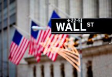 America Is BOOMING – Record Numbers Announced! Wall Street sign with American flags in the background