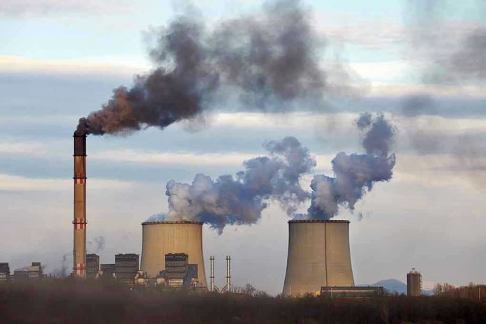 1555865300 Industrial plant emitting black smoke into the sky.