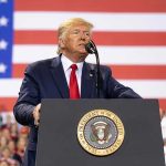 Trump’s Fortress CRUMBLES — RNC Chair Exposes ALL! Man speaks at podium with U.S. flag background.