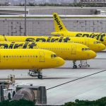 Gunfire RIPS Airliner – Flights Halted Nationwide! Yellow airplanes parked on the airport tarmac.