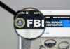 Tucker Carlson SLAMS FBI Over Shooter Cover-Up FBI website shown through magnifying glass.