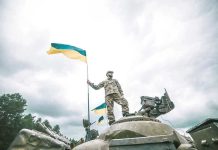 Ukraine Releases KILLER Robot Trucks – Military World STUNNED Soldier on tank holding Ukrainian flag.