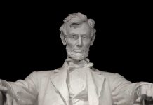 Marble statue of Abraham Lincoln seated with a serious expression