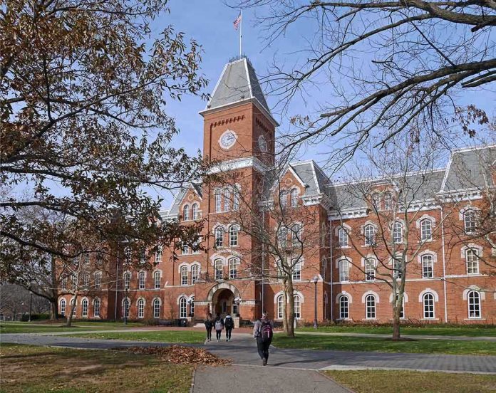 shutterstock_238536373.jpg Historic university building with students walking in front during autumn