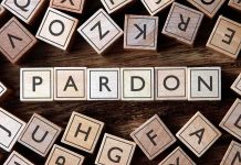 Trump FREES Billion-Dollar Scammer After Two Weeks Wooden letter blocks arranged to spell 'PARDON' on a wooden surface
