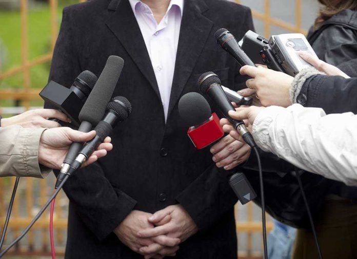 shutterstock_63766933.jpg A group of microphones surrounding a person at a press conference