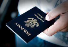 SCOTUS Shocks with Passport Ruling – Changes Coming A person holding a United States passport with a dark background