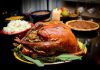 SHOCKING Benefits of “Bad” Thanksgiving Foods A beautifully roasted turkey on a festive table surrounded by side dishes and decorations