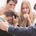 Forced Involuntary Commitments Expand Nationwide Group comforting a distressed person with hand on shoulder.