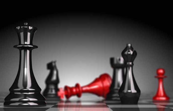 135258992 Black and red chess pieces on a board.