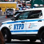Unfit Cops Keep Jobs – Standards Crumble NYPD police car on a city street scene.