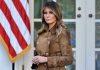 Trump’s Ukraine Deal IMPLODES – Melania Steps In Woman in brown coat beside American flag.