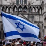 Israeli flag at a crowded outdoor event.