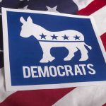 Disgraced Dem Plots Comeback – Outrageous Governor Bid Democrats logo on American flag background