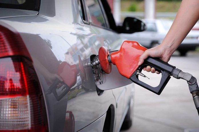 A person refueling a car at a gas station
