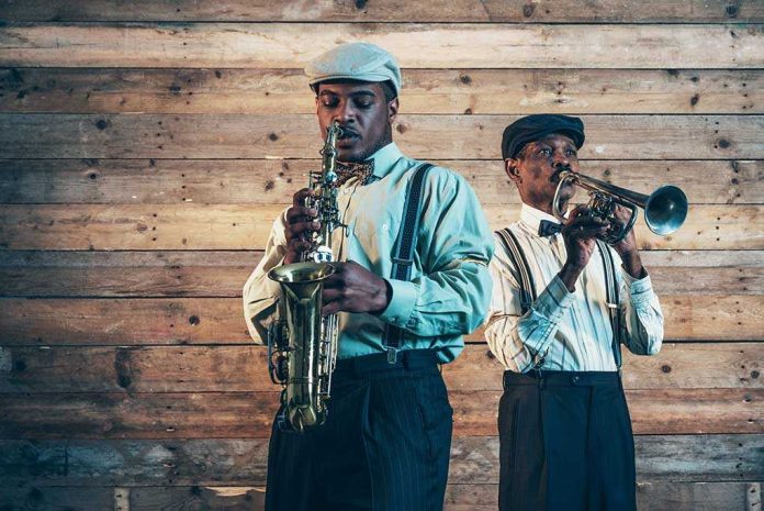 Two jazz musicians playing saxophone and trumpet against a wooden wall