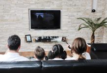 LGBT Characters in Kids’ TV: Inclusivity or Overreach? A family of four watching television together in a cozy living room