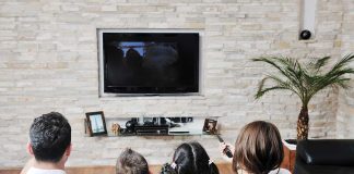 LGBT Characters in Kids’ TV: Inclusivity or Overreach? A family of four watching television together in a cozy living room