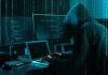 Massive ICE Data Breach Ignites Security Panic Hacker in dark room surrounded by computer screens.