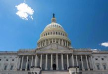U.S. Capitol building against a clear blue sky.