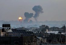 Flames and smoke billowing over a cityscape.