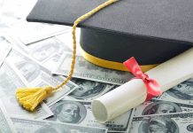 Graduation cap and diploma resting on a pile of money