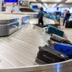 Luggage on a conveyor belt at an airport baggage claim area