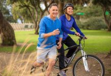 Major Depression Breakthrough: Exercise Dominates A couple enjoying outdoor exercise, with one riding a bike and the other jogging alongside