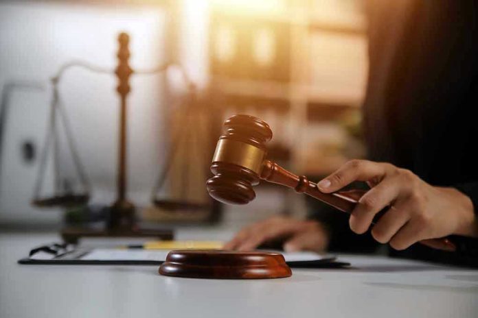 2478909667 Gavel being struck near scales of justice.