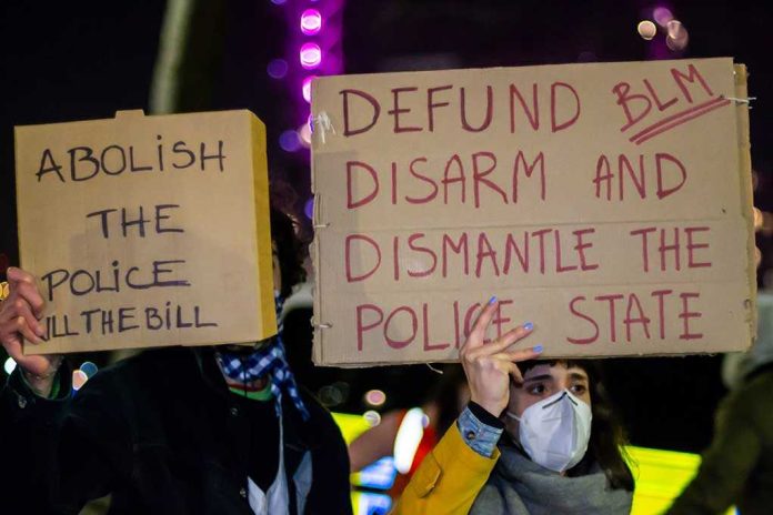 shutterstock_1943473279.jpg Two individuals holding protest signs with messages about police reform
