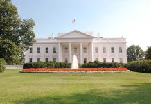 The White House surrounded by manicured gardens and a fountain