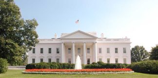 The White House surrounded by manicured gardens and a fountain