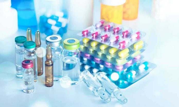 1298903665 Vials and blister packs of pills on table.