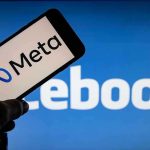 Monopoly Scheme EXPOSED—Meta’s Breakup Looms Meta on phone screen, Facebook in background.